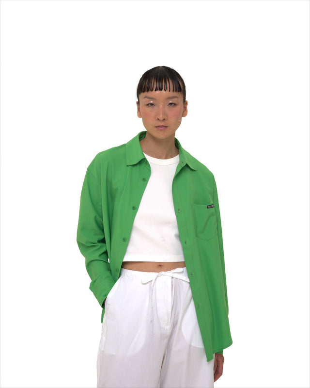 Female model front view wearing unbuttoned Vault Urban green Stay Fresh shirt – wrinkle-free sustainable women’s workwear