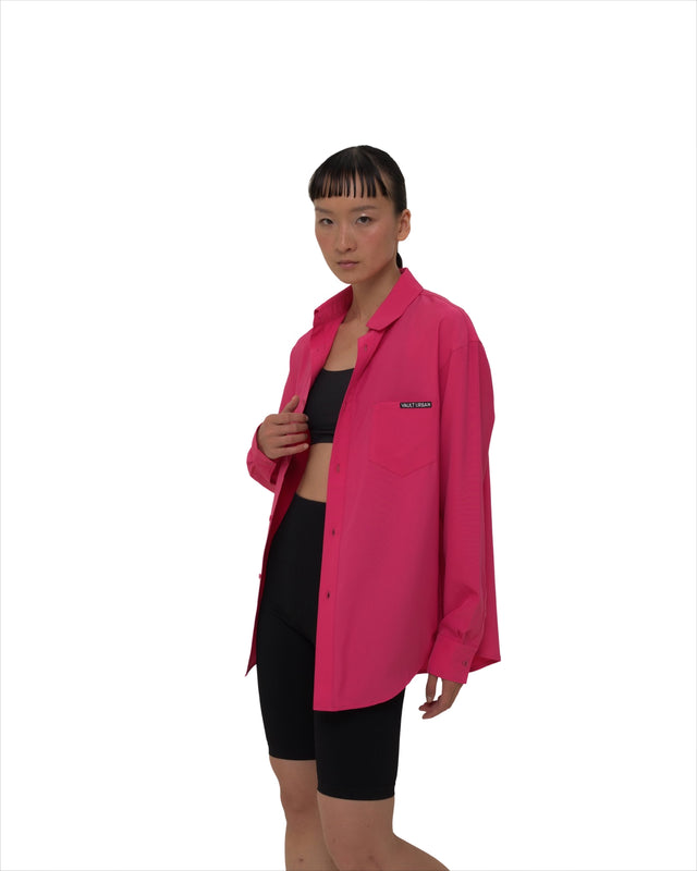 Angled view of female model in Vault Urban pink Stay Fresh shirt – versatile sustainable women’s workwear