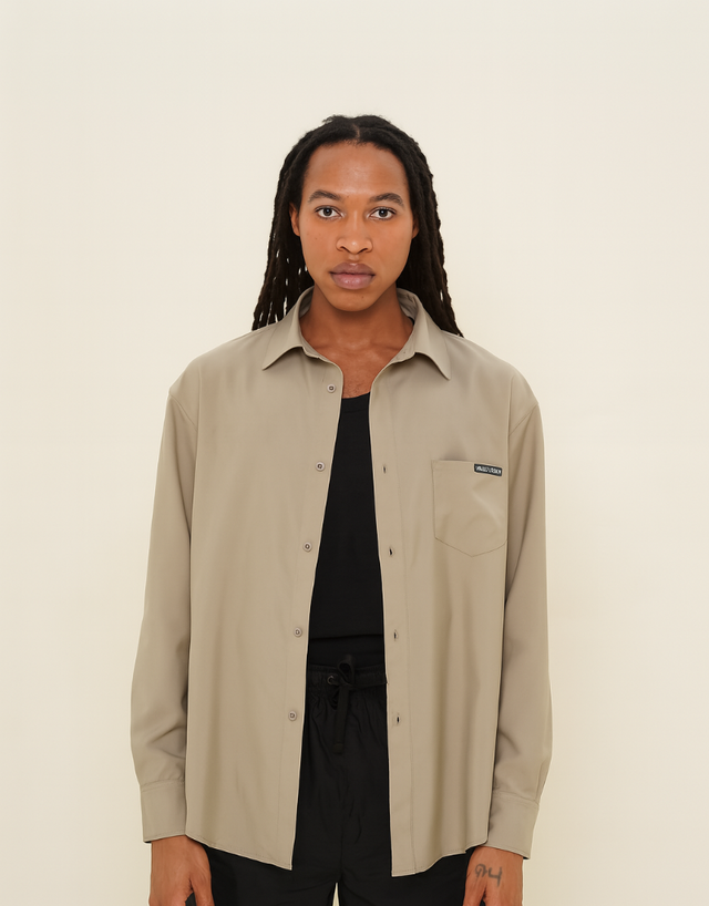 Vault Urban taupe performance shirt worn open over a black top and shorts, showcasing a modern and versatile everyday look