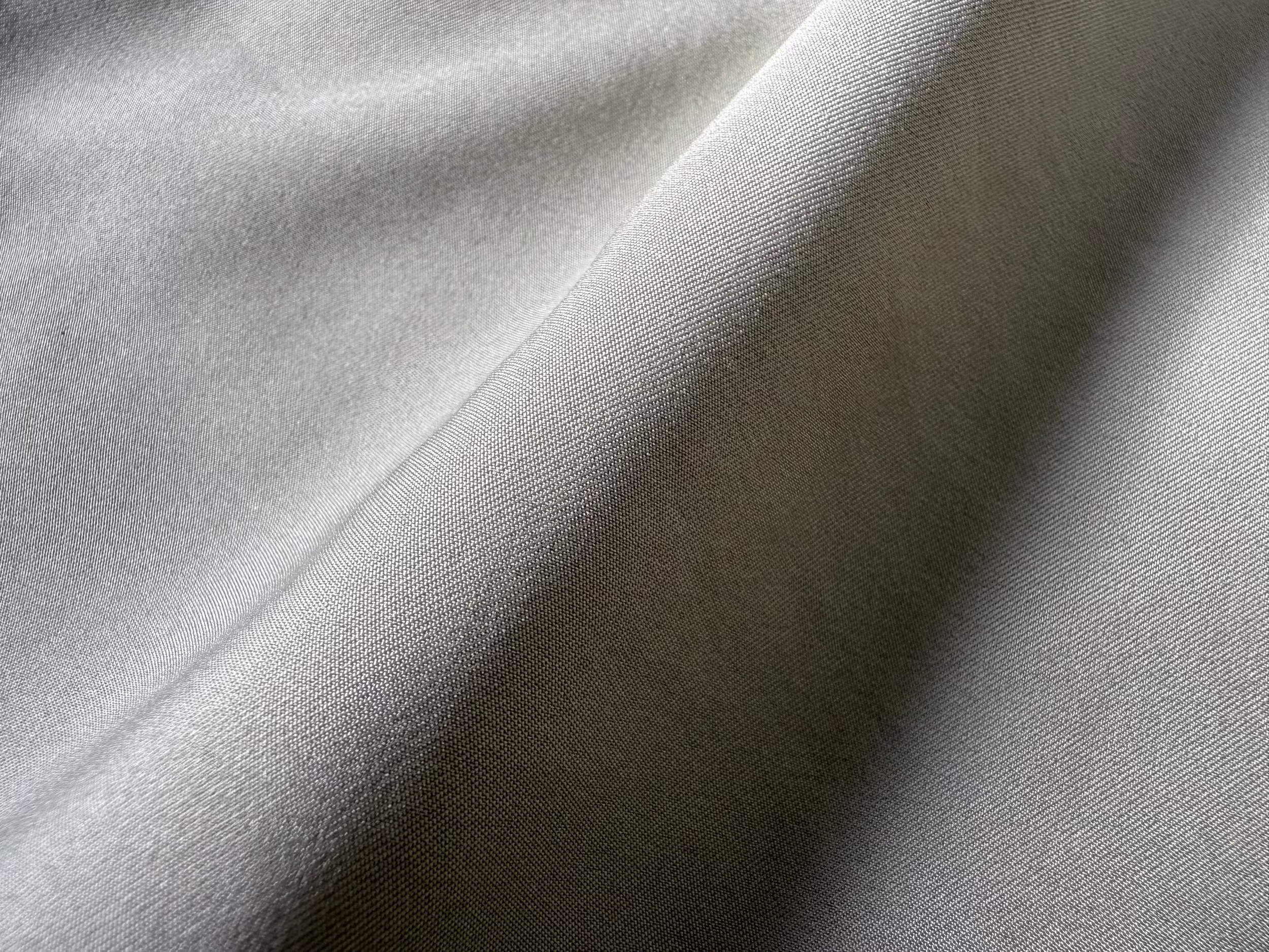 Close-up of Vault Urban shirt fabric in taupe green, showing smooth texture and sustainable high-performance weave